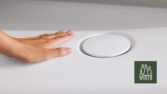 Egy kéz megsimítja a padlóba süllyesztett CleanFloor30 zuhanyfelületet Egy kéz megsimítja a padlóba süllyesztett CleanFloor30 zuhanyfelületet